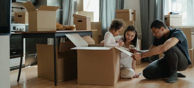 A family and cardboard boxes of various sizes and types 