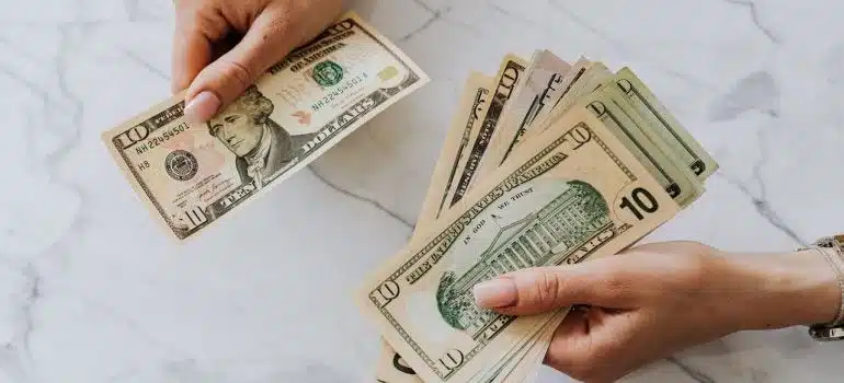 hands with dollar bills 
