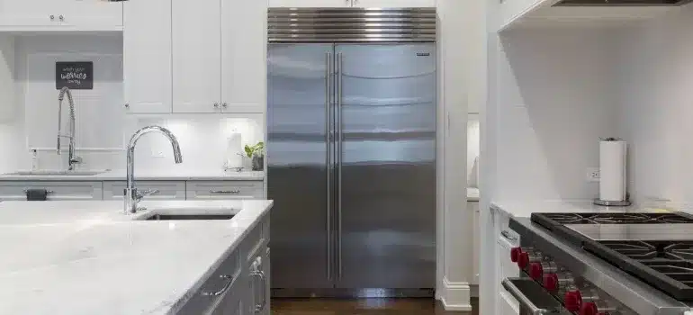 Refrigerator beside kitchen cabinet