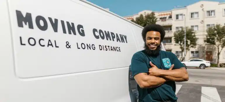 A mover standing in front of his moving van