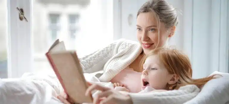 A mom with her daughter reading