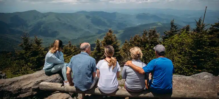 Family sitting at the summit and enjoying the scenic view.
