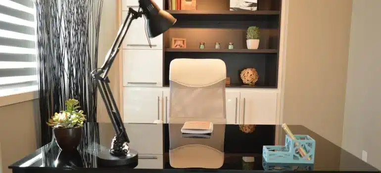 An office desk with a chair and a lamp