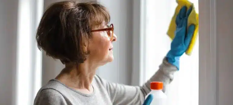 A woman thinking about how to deep clean a new home after moving to Somersworth
