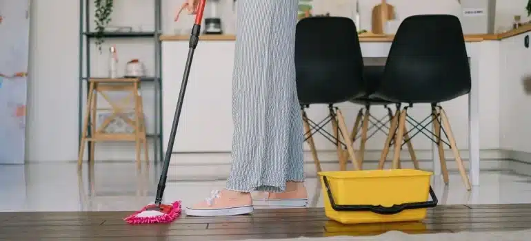 A woman cleaning with a mop