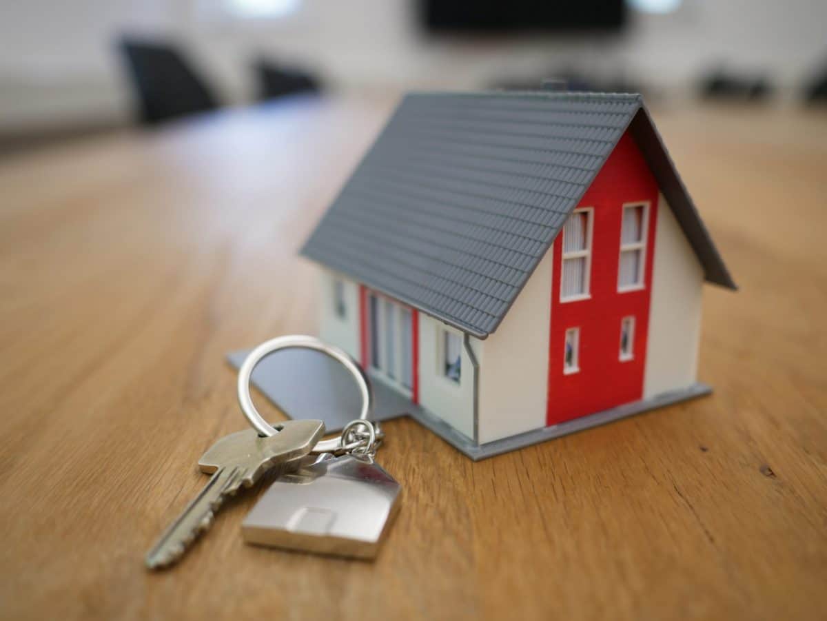 a small house and key chains on the table
