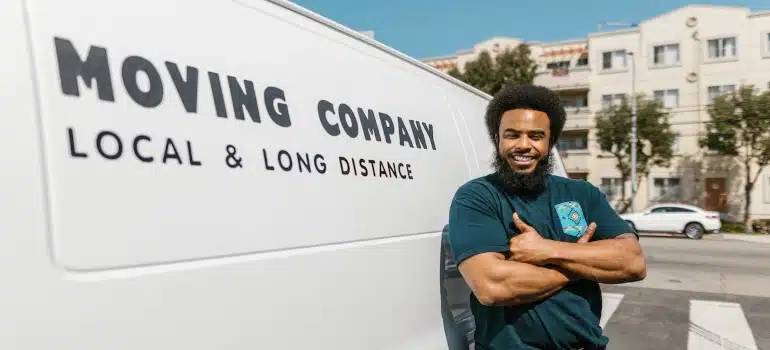 a man standing in front of a moving company truck