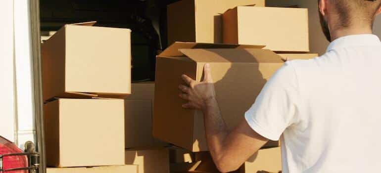 A mover loading up a truck with moving boxes