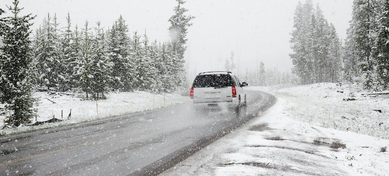 A car traveling on a road during the winter