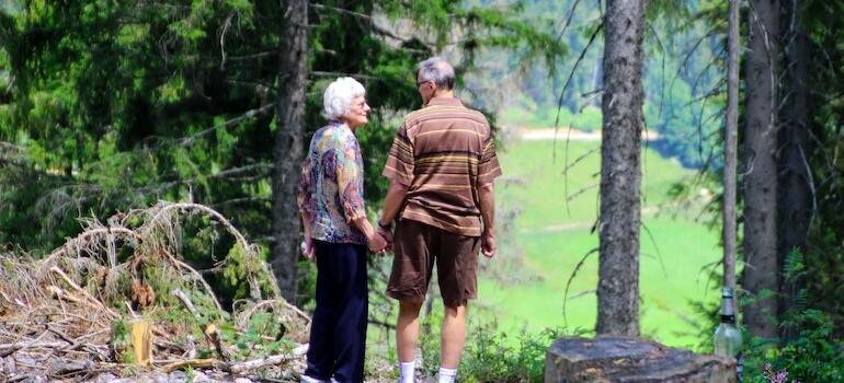 A senior couple walking in a forest